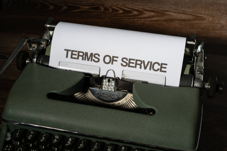 A sheet of paper in a typewriter that says “terms of service” on it