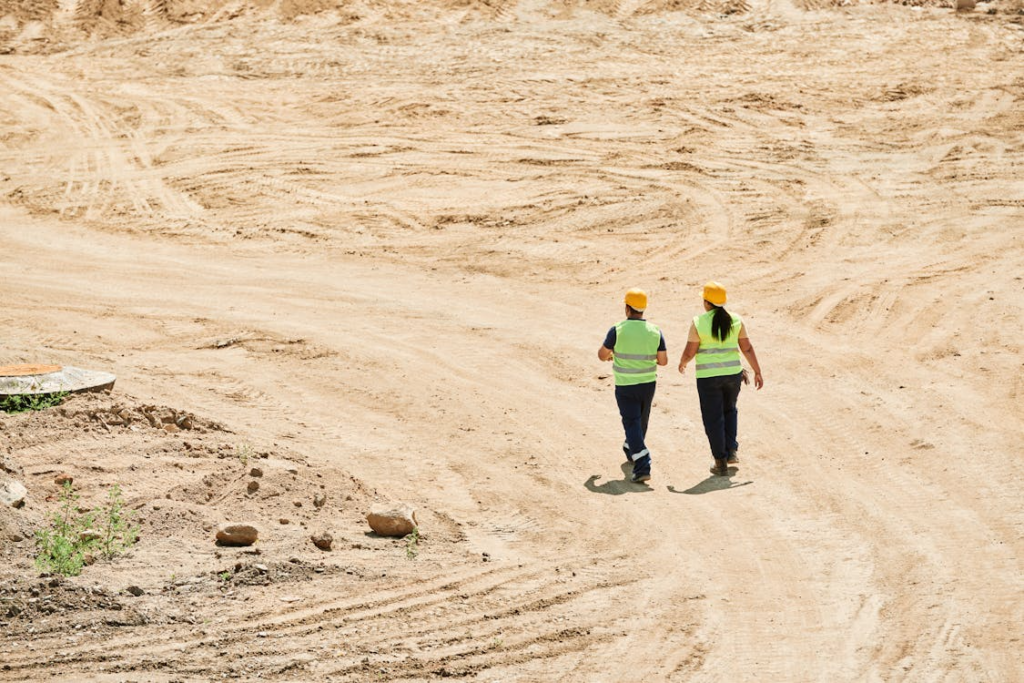 Two workers walking on a remote jobsite